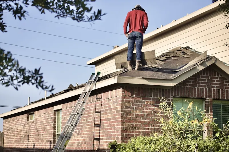 Professional roofer working on a residential roof in Gross Point